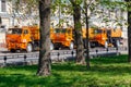 Moscow, Russia - May 01, 2019: Three large orange sprinkler trucks with plastic water tanks parked on Moscow street in sunny