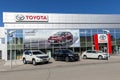 Toyota dealership with a modern facade and cars on display in front of the retail center