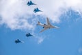 Moscow, Russia - May, 05, 2021: The Tu-160 strategic missile carrier, accompanied by four Su-35S fighter jets, flies over Red Royalty Free Stock Photo