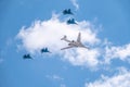 Moscow, Russia - May, 05, 2021: The Tu-160 strategic missile carrier, accompanied by four Su-35S fighter jets, flies over Red Royalty Free Stock Photo