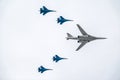 Moscow, Russia - May, 05, 2021: The Tu-160 strategic missile carrier, accompanied by four Su-35S fighter jets, flies over Red Royalty Free Stock Photo