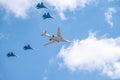 Moscow, Russia - May, 05, 2021: The Tu-160 strategic missile carrier, accompanied by four Su-35S fighter jets, flies over Red Royalty Free Stock Photo