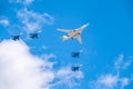 Moscow, Russia - May, 05, 2021: The Tu-160 strategic missile carrier, accompanied by four Su-35S fighter jets, flies over Red Royalty Free Stock Photo