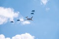 Moscow, Russia - May, 05, 2021: The Tu-160 strategic missile carrier, accompanied by four Su-35S fighter jets, flies over Red Royalty Free Stock Photo