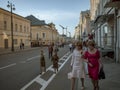 MOSCOW, RUSSIA - MAY 9, 2016: Two little girls in military historical clothing and two women in business suits are walking