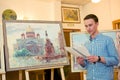 MOSCOW, RUSSIA, MAY 19, 2014: Unidentified teenager boy graduating the art school with his diploma painting works, May 19, 2014.