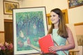 MOSCOW, RUSSIA, MAY 19, 2014: Unidentified teenager girl graduating the art school with his diploma painting works, May 19, 2014.