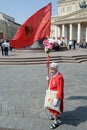 Unknown elderly woman with a red flag at the Moscow Bolshoi theatre on victory Day