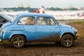 Moscow, Russia - May 25, 2019: Vintage and rare Soviet car ZAZ 965 Zaporozhets. Blue car rides on the field soiled with mud