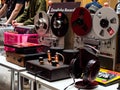 Vintage tape players, tube amplifier, headphones on stand, vinyl records at the exhibition