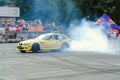 Moscow, Russia - May 25, 2019: Yellow Drift bmw hatchback. Tuned car drifting in the fenced area. Burnout