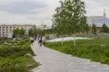 Moscow, Russia - May 28, 2021: Zaryadye park in the center of the capital a paved path and a green lawn, a modern fashionable