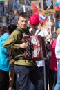 Musician wearing military uniform with accordion on parade of Victory Day.