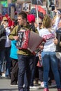 Musician wearing military uniform with accordion on parade of Victory Day.