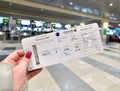 Moscow, Russia - 17 Nov. 2019. Boarding pass of Qatar Airways in a female hand on the background of Domodedovo International