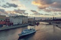 Beautiful sunset over Moskva river and a touristic boat cruising