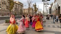 Moscow, Russia - November 12, 2019: Hari Krishna people, women in colorful sari walk along the street, sing and dance, holiday