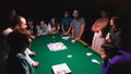 People playing alias game at the party on the pool table