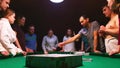 People playing alias game at the party on the pool table
