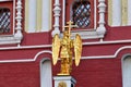 Moscow, Russia - Oct 10. 2021. Gilded figure of an angel with a cross on Iverskaya Chapel of the Resurrection Gates in