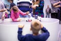 Moscow, Russia - October 04, 2019: child girl plays with Aibo Robotic pets designed and manufactured by Sony Pet robot