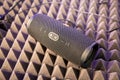 Moscow, Russia - October 04, 2019: close up of black portable bluetooth waterproof music speaker JBL Charge 4 rests on noise