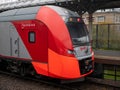 Moscow, Russia - October 5, 2021: Close-up on the bright red train Swallow arriving at the station of the Moscow central ring