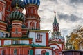 Moscow, Russia - October 08, 2019: Colored domes of Saint Basil Cathedral on Red square close-up against Spasskaya tower of Moscow Royalty Free Stock Photo