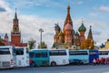 Moscow, Russia - October 08, 2019: Colored tourist buses parked against Spasskaya tower of Moscow Kremlin and Saint Basil Royalty Free Stock Photo