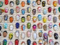 Moscow, Russia, 21 October 2019: Colorful painted ceramic faces sculpture on the bricks wall as an the object of modern
