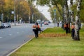 Moscow. Russia. October 11, 2020 Community workers use a blower to remove fallen leaves from city streets and parks