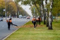 Moscow. Russia. October 11, 2020 Community workers use a blower to remove fallen leaves from city streets and parks.