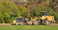 MOSCOW, RUSSIA - OCTOBER 22, 2018: Foliage harvesting with New Holland L218 skid steer loader and SDLG LG936L wheel loader