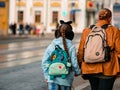 Moscow, Russia - October 19, 2019: A girl with a braided pigtail in funny hat in shape of an animal with ears and with a blue