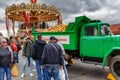 Moscow, Russia - October 05, 2019: Green truck with ripe apples in the back on Red Square against dramatic cloudy sky. Traditional