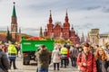 Moscow, Russia - October 05, 2019: Green truck with ripe apples in the back on Red Square against State Historical Museum at sunny