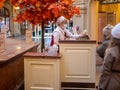 Moscow, Russia - October 5, 2021: GUM is the main department store. Masked seller is serving a stanchik of Soviet ice cream sundae