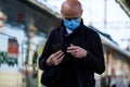 Moscow. Russia. October 4, 2020. A lone bald man in a protective medical mask and headphones walks along railway