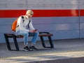 Moscow. Russia. October 4, 2020. A lone man wearing a protective medical mask sits on a bench of a railway station