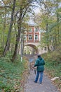 Man painting building with arch in the autumn museum-estate `Arkhangelsk` in Moscow