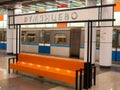 Moscow, Russia - October 5, 2021: Moscow metro, Rumyantsevo station. Bright orange bench. In the background, a train in motion