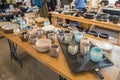 Moscow, Russia, October 5, 2019: multi-Colored ceramic mugs in a pottery workshop on a wooden table, exhibition and sale of Royalty Free Stock Photo