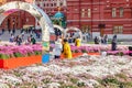 Moscow, Russia - October 08, 2019: People walking on Manezhnaya Square in Moscow at sunny autumn day. Decorative installations of