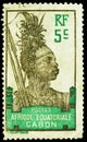 Postage stamp printed in Gabon shows Warrior, Definitive - Warrior - Libreville - Bantu Woman (Congo) serie, 5 French centime,