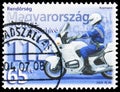 Postage stamp printed in Hungary shows Policeman on motorbike and emergency phone number, Police serie, circa 2003 Royalty Free Stock Photo