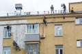 Moscow. Russia. October 10, 2020. A professional team of workers paints the wall of a building. Industrial alpinism