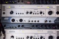 A rack of audio compressors in a recording studio