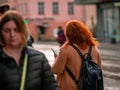 Moscow, Russia - October 19, 2019: Red-haired young plump woman holds a smartphone in her hand and walks along the street. People Royalty Free Stock Photo