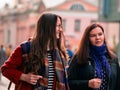 Moscow, Russia - October 19, 2019: Two girlfriends walk along the street and have a fun conversation. Young women are walking in