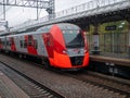 Moscow, Russia - October 5, 2021: View of the bright red train Swallow arriving at the station of the Moscow central ring